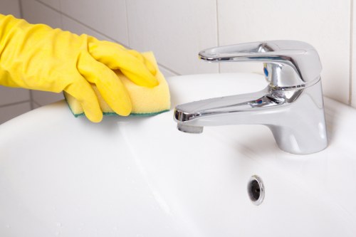 House cleaning tasks in a SW15 kitchen and bathroom during a routine domestic clean